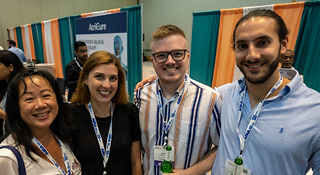 4 smiling attendees at the networking reception