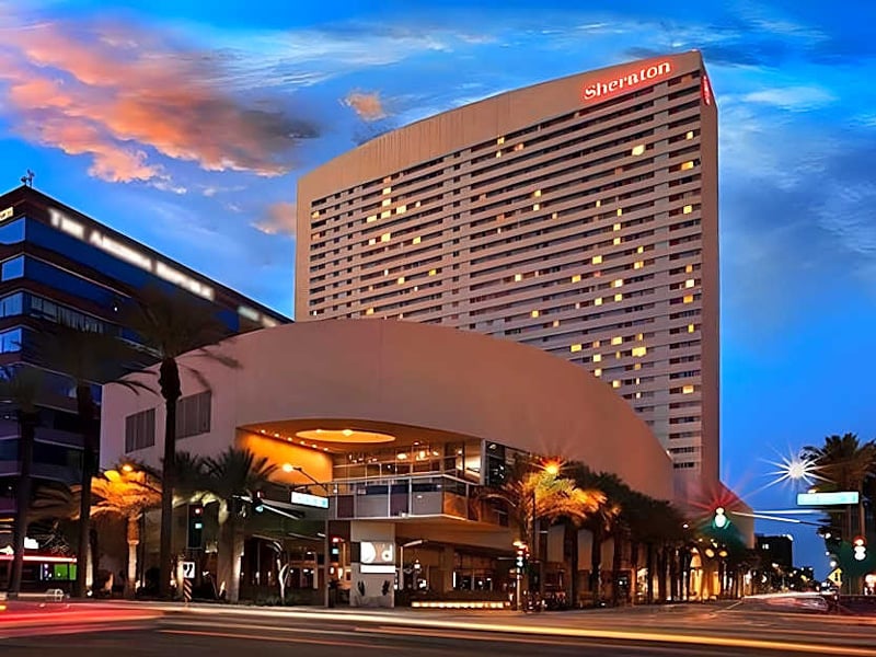 Outdoor photo of the Sheraton Hotel in the evening.