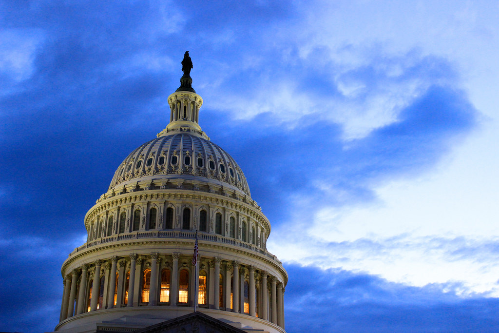 Capital Building Capital Building dome in Washington, DC, lit up at dusk with a dark blue cloudy sky