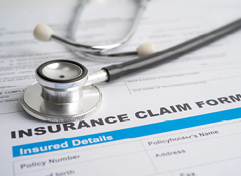 A stethoscope on top of an insurance claim form representing healthcare payments